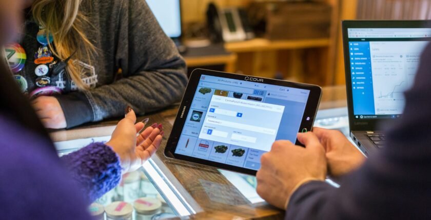 Sales jobs in Pakistan: salesperson showing a product on a tablet to a customer