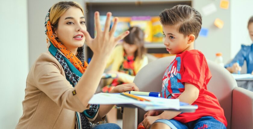 Teacher teaching a young child in a classroom, representing teaching jobs in Pakistan
