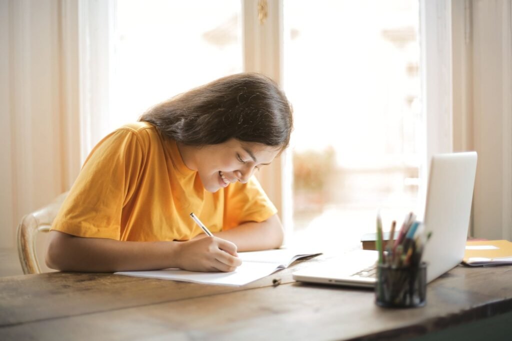 Cover letter for freshers: student writing a letter at a desk