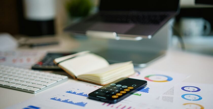 Accounting jobs in Pakistan: calculator and documents on an accountant's desk with laptop