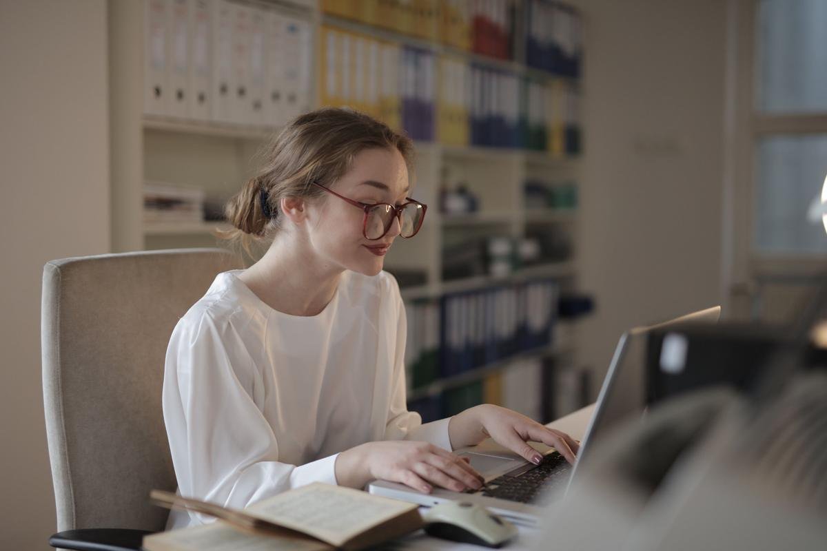 Woman working on a laptop in an office