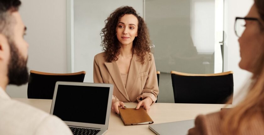 A job candidate talking with interviewers after learning how to prepare for a job interview
