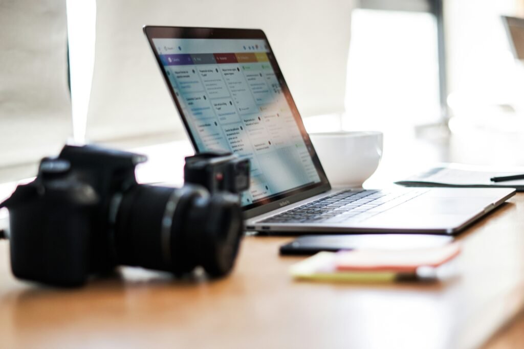Camera and laptop on a desk, representing digital marketing jobs in Pakistan