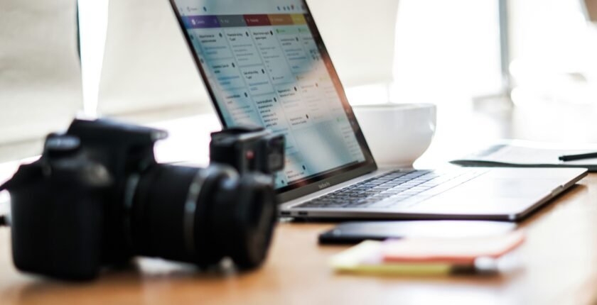 Camera and laptop on a desk, representing digital marketing jobs in Pakistan