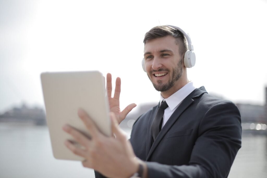 LinkedIn profile for freshers: smiling man waving during an online video call